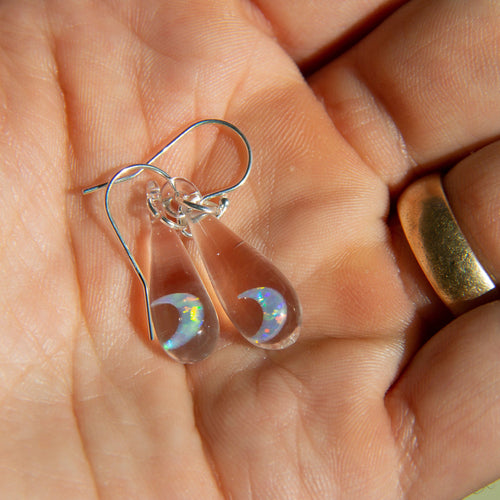 Pair of glass earrings with opal moons inside