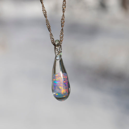 Glass pendant with encased opal